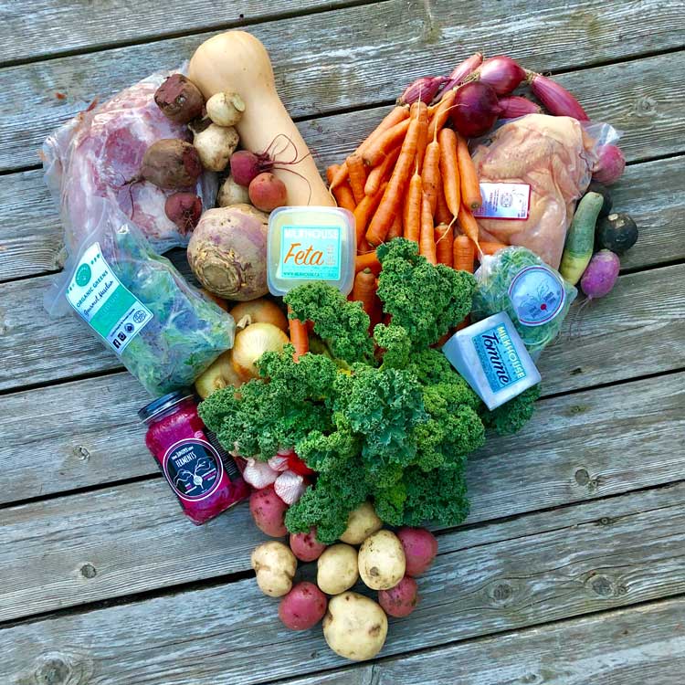 Fruits, vegetables, and other food items placed in the shape of a heart
